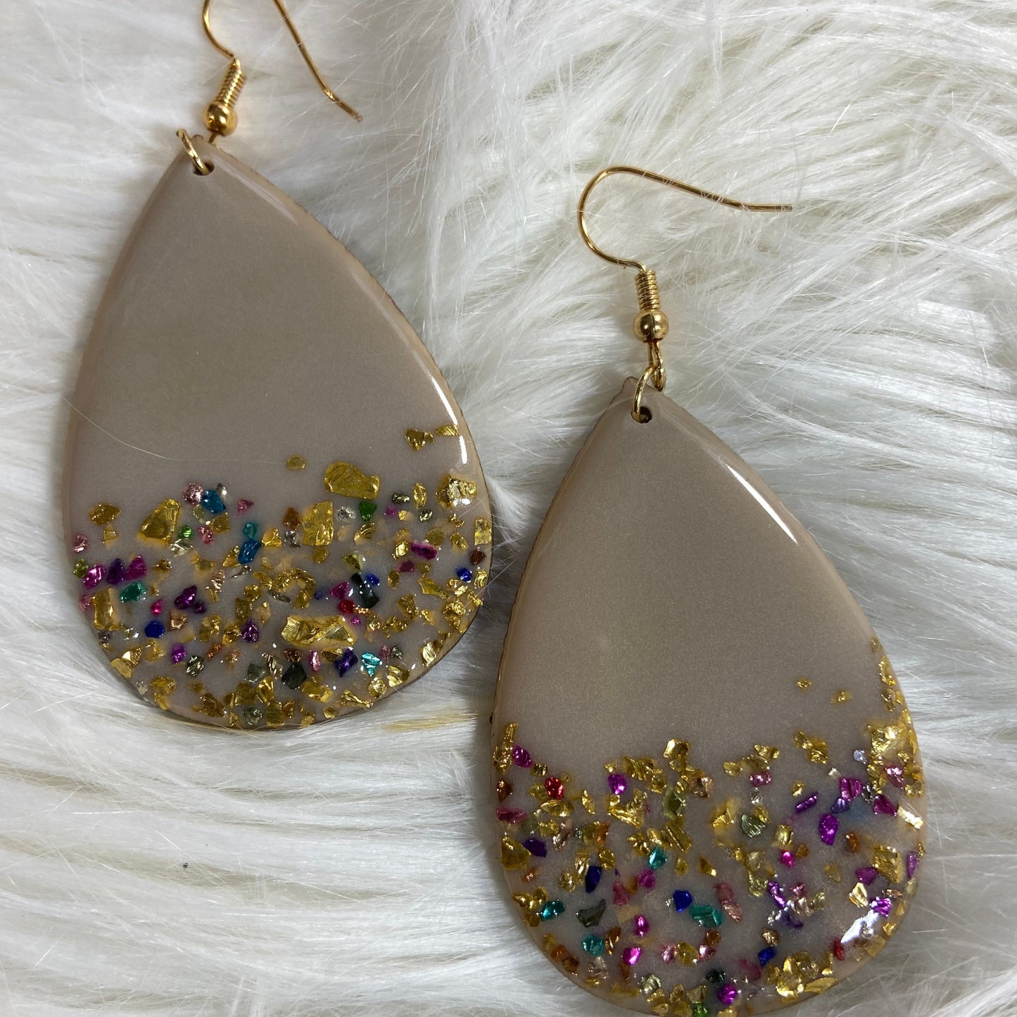 Pair of tan teardrop earrings with earthy resin tones and tiny multicolor glass chips