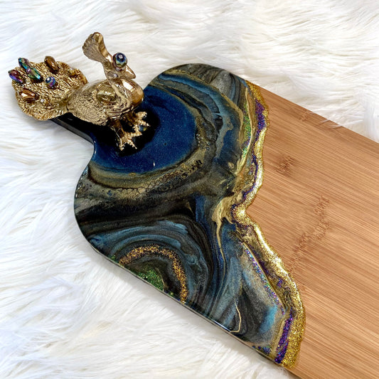 Detail of Peacock Royale bamboo serving board featuring rich blue and gold resin art
