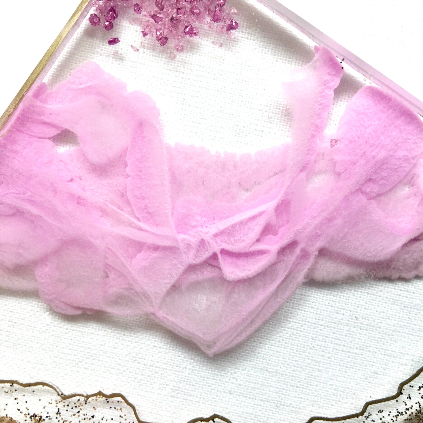 Close up view of resin ribbons on pink and clear geode coasters - Mamota Creative