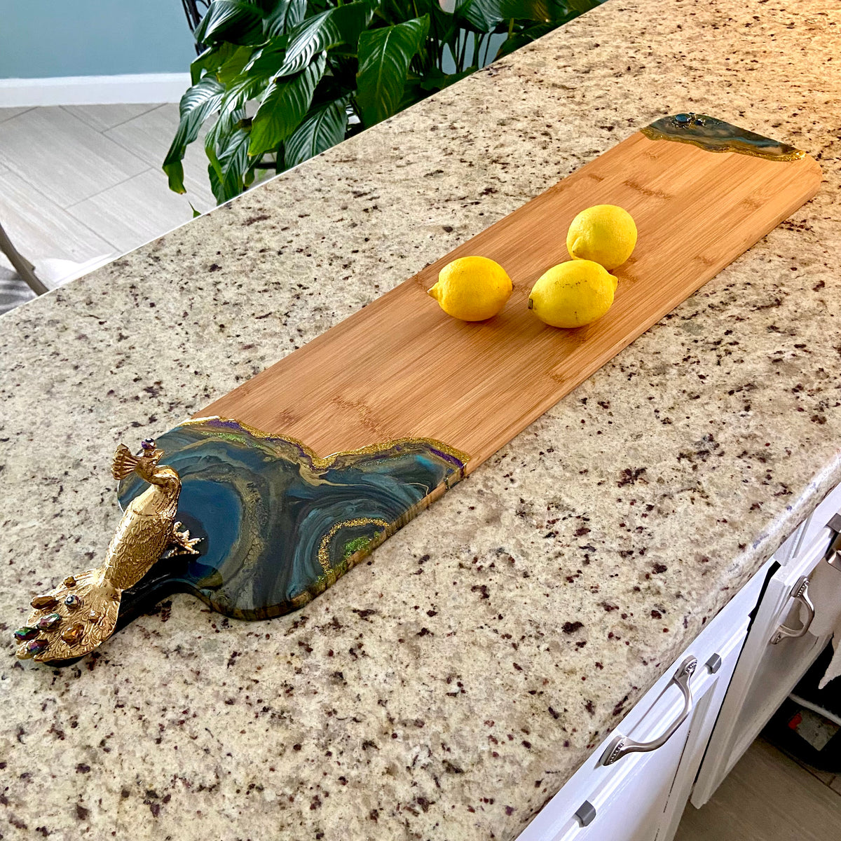 Peacock Royale serving board measuring 36 inches long with resin art embellishment