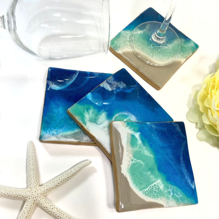 Set of 4 beach waves theme coasters displayed on a white surface