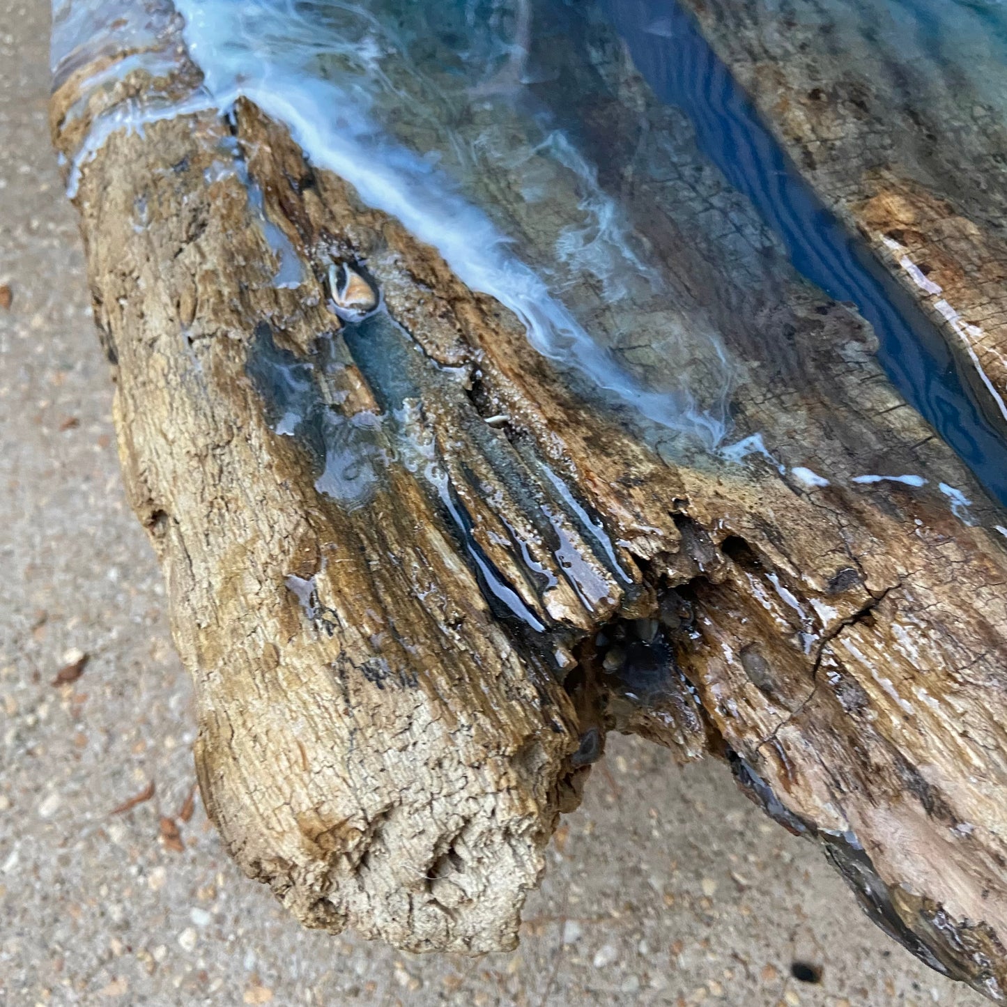 Partial image of a blue resin wave on organic wood
