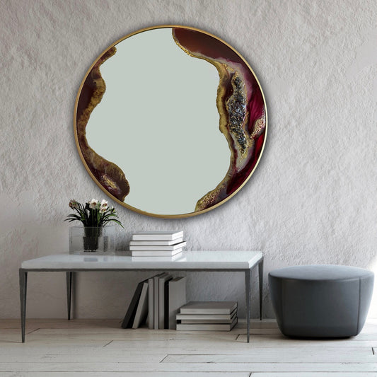Hung on a modern decor gray wall burgundy and gold geode-style resin mirror with dimensional decorative texture