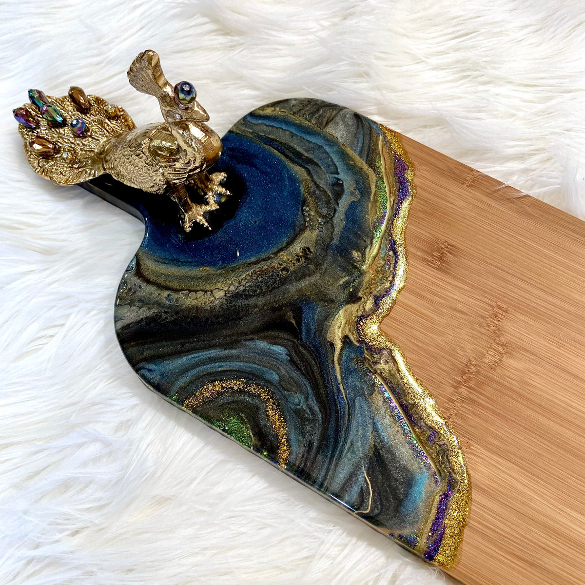 Detail of Peacock Royale bamboo serving board featuring rich blue and gold resin art