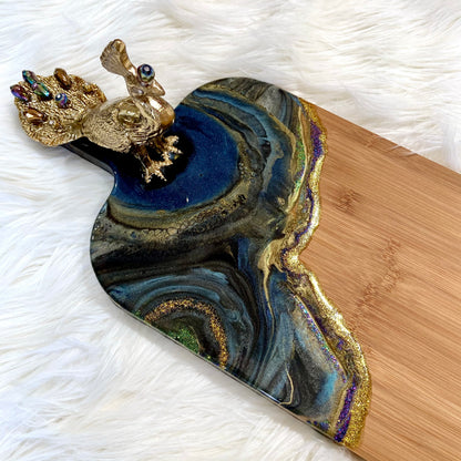 Detail of Peacock Royale bamboo serving board featuring rich blue and gold resin art