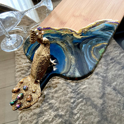 Peacock Royale XL bamboo serving board with blue, teal, green, black, and gold resin art