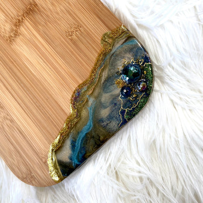 Handcrafted Peacock Royale XL bamboo serving board with decorative brass peacock