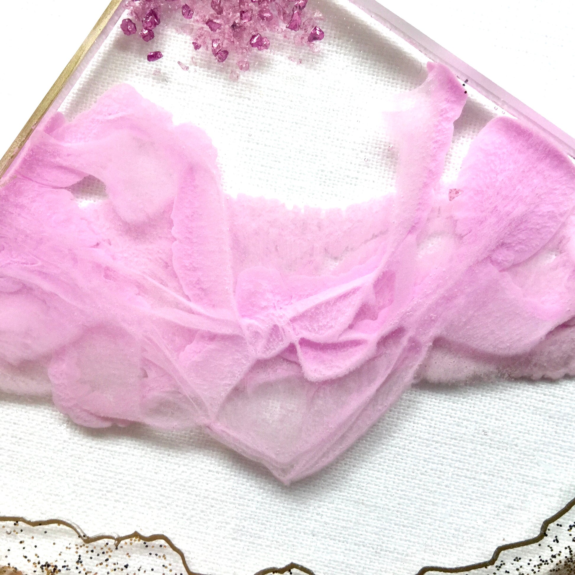 Close up view of resin ribbons on pink and clear geode coasters - Mamota Creative