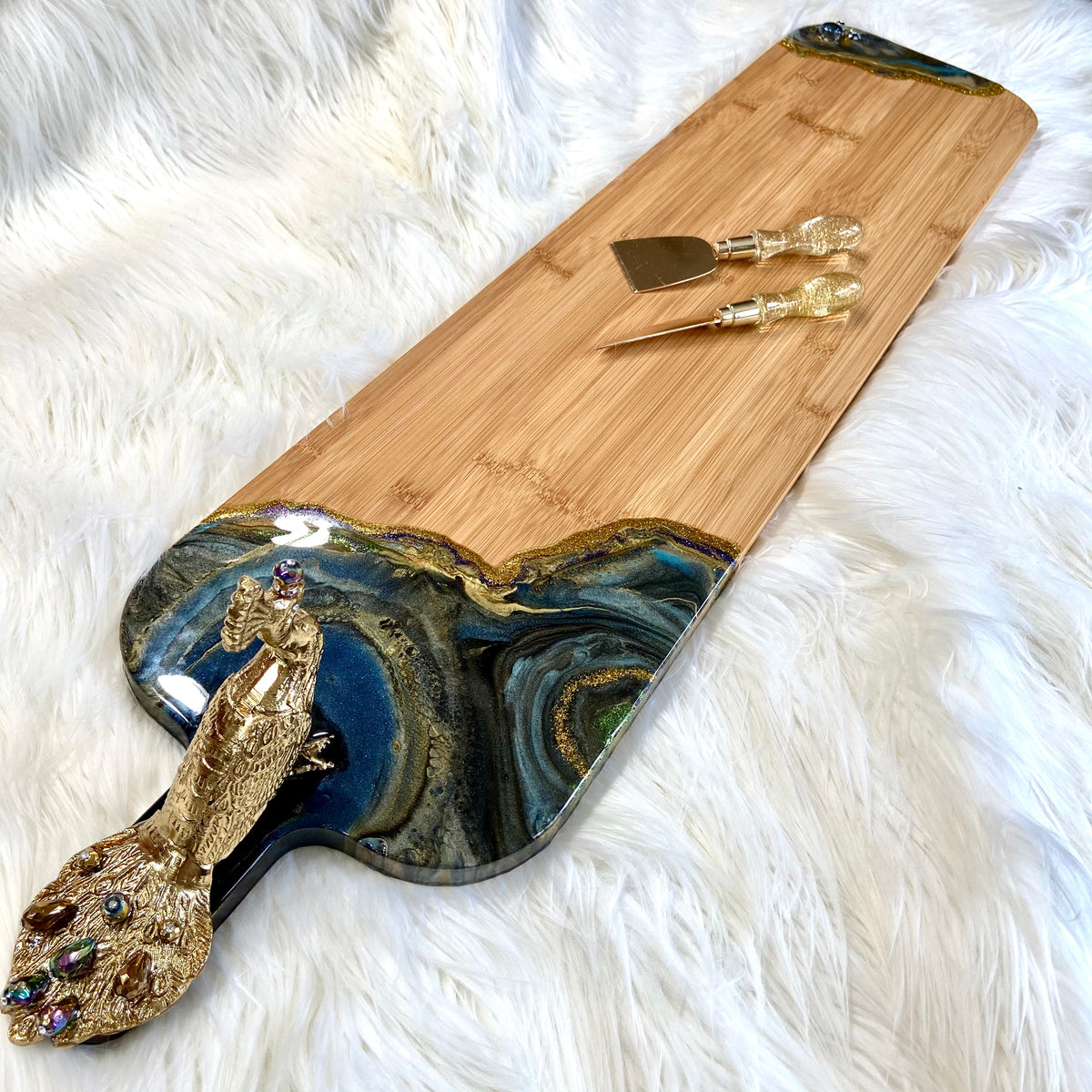 Close-up of the beaded brass peacock embellishment on the Peacock Royale serving board