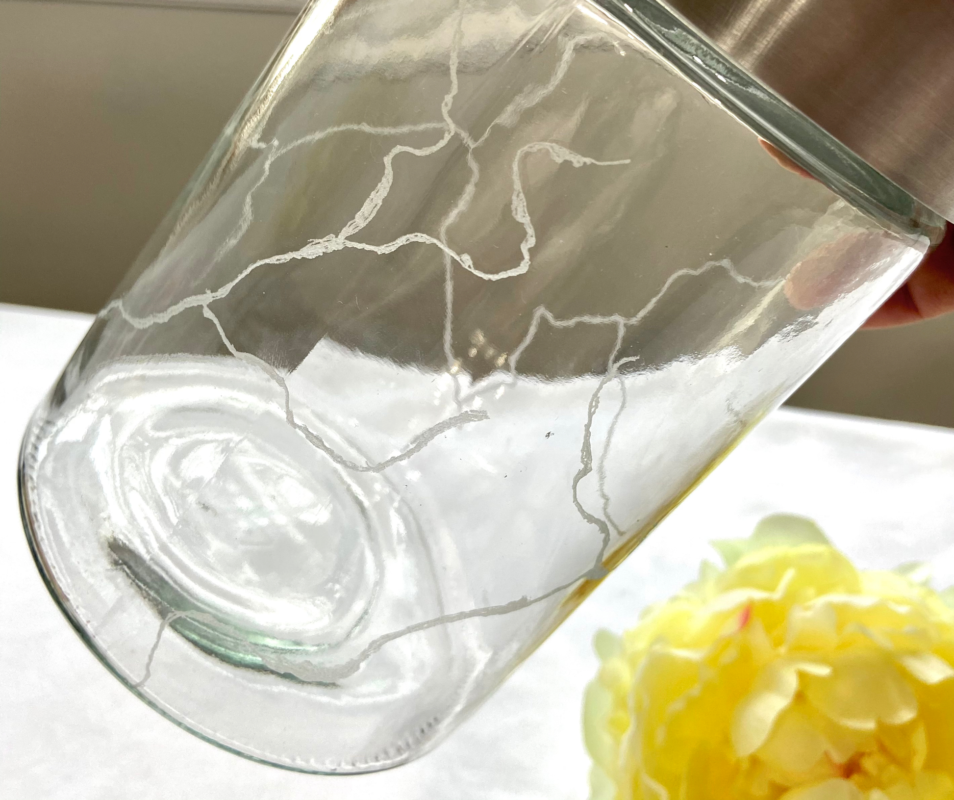 a close view of the engraved cracks of glass jar - Mamota Creative